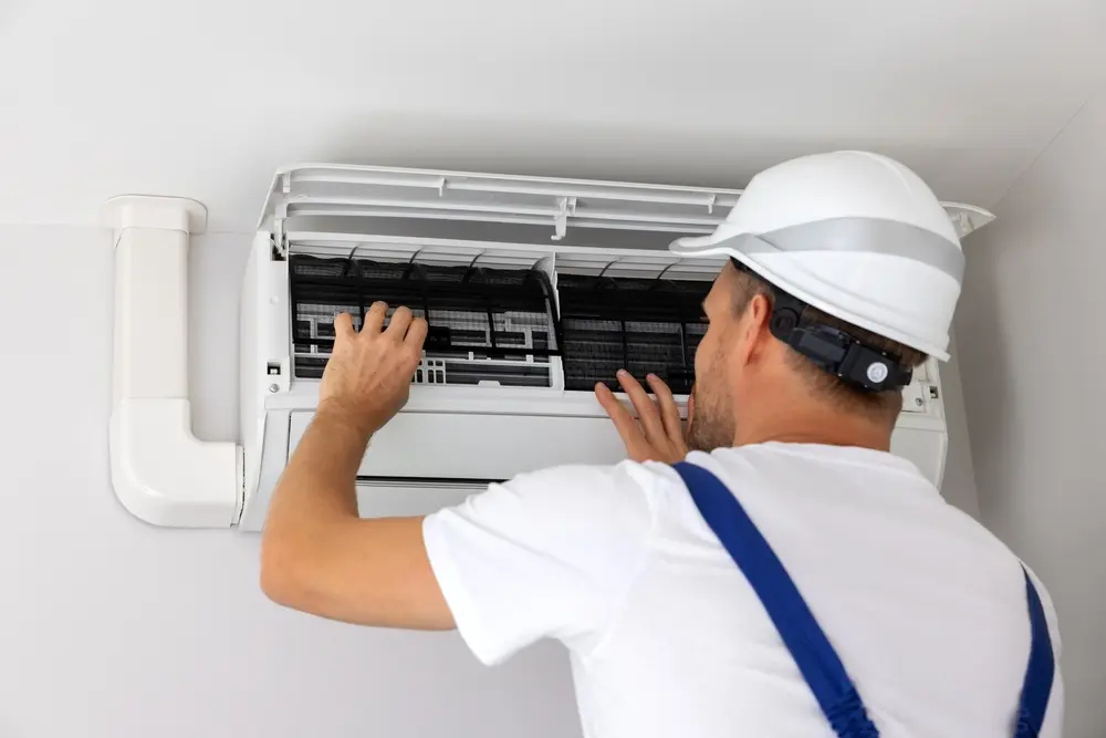 air conditioner maintenance and repair. hvac service technician at work