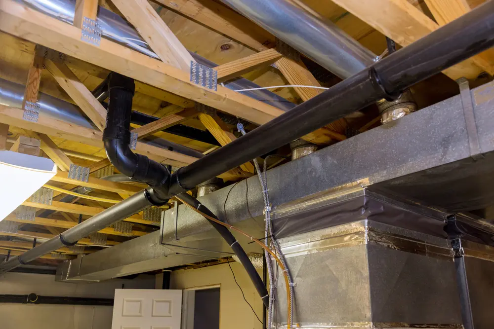 framed home installation of air conditioner and heating ductwork in ceiling of a new home HVAC