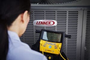 Lennox AC condenser unit being inspected